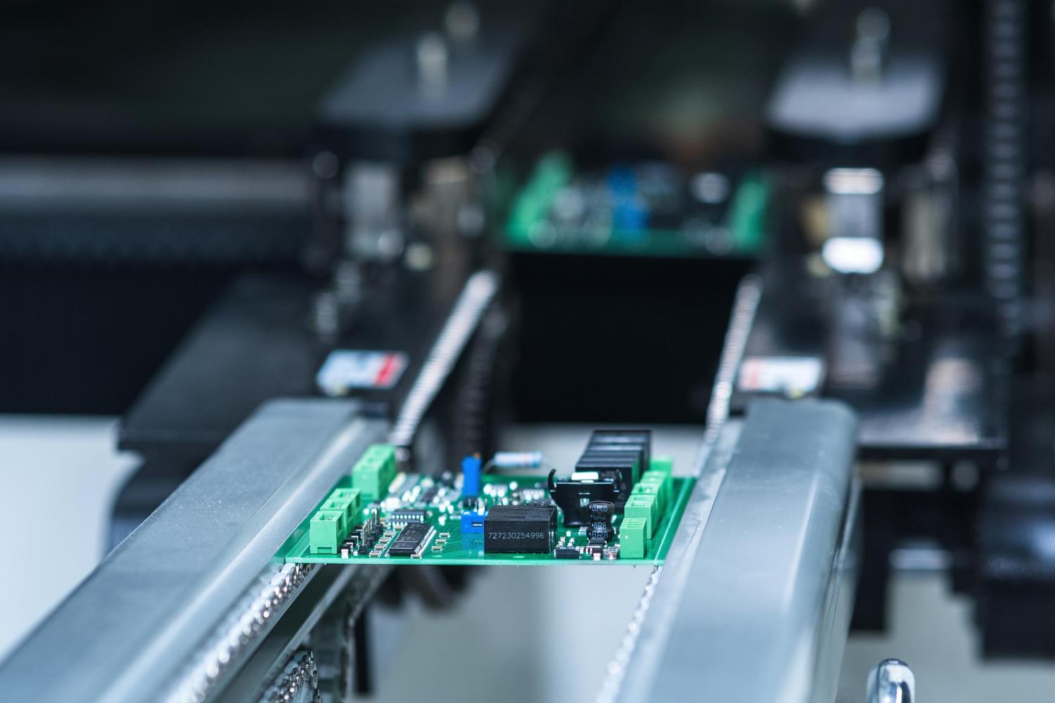 Printed circuit board travelling through an electronics production line
