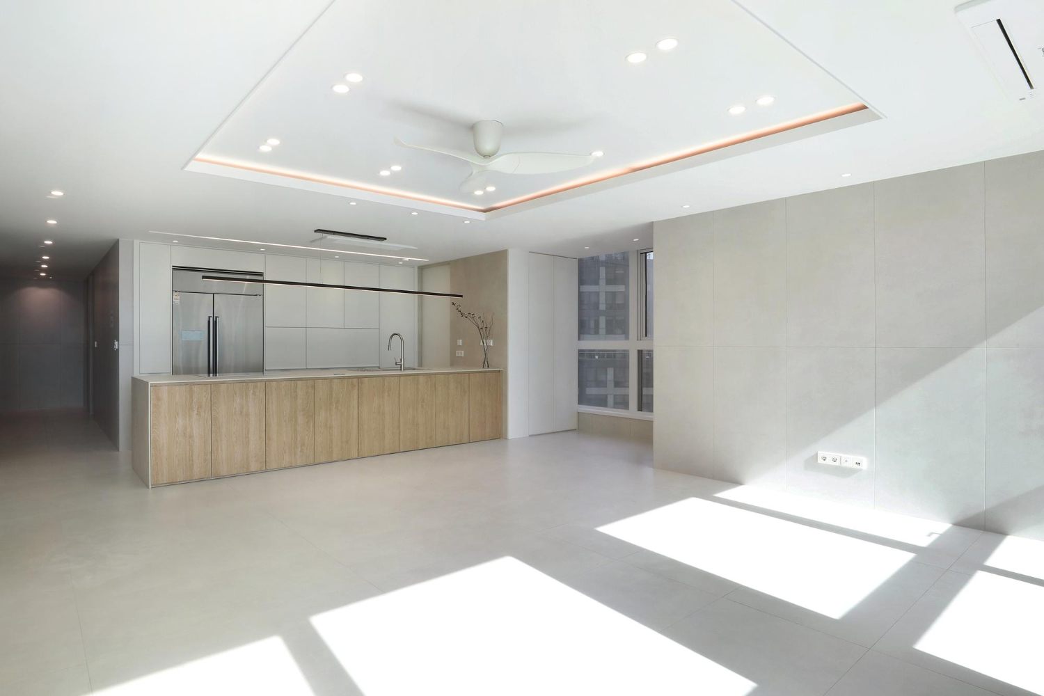Wide open living area showing a ceiling fan in relation to the room
