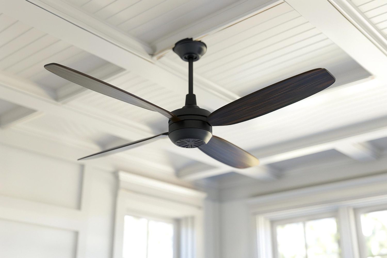 Close view of a modern ceiling fan motor housing and blades