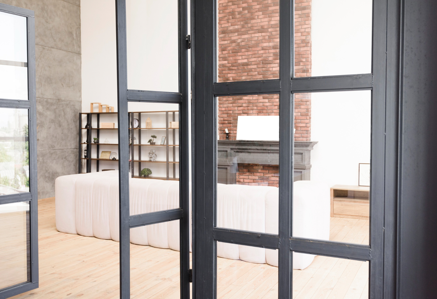 Dark-framed glass partition beside a bright living room