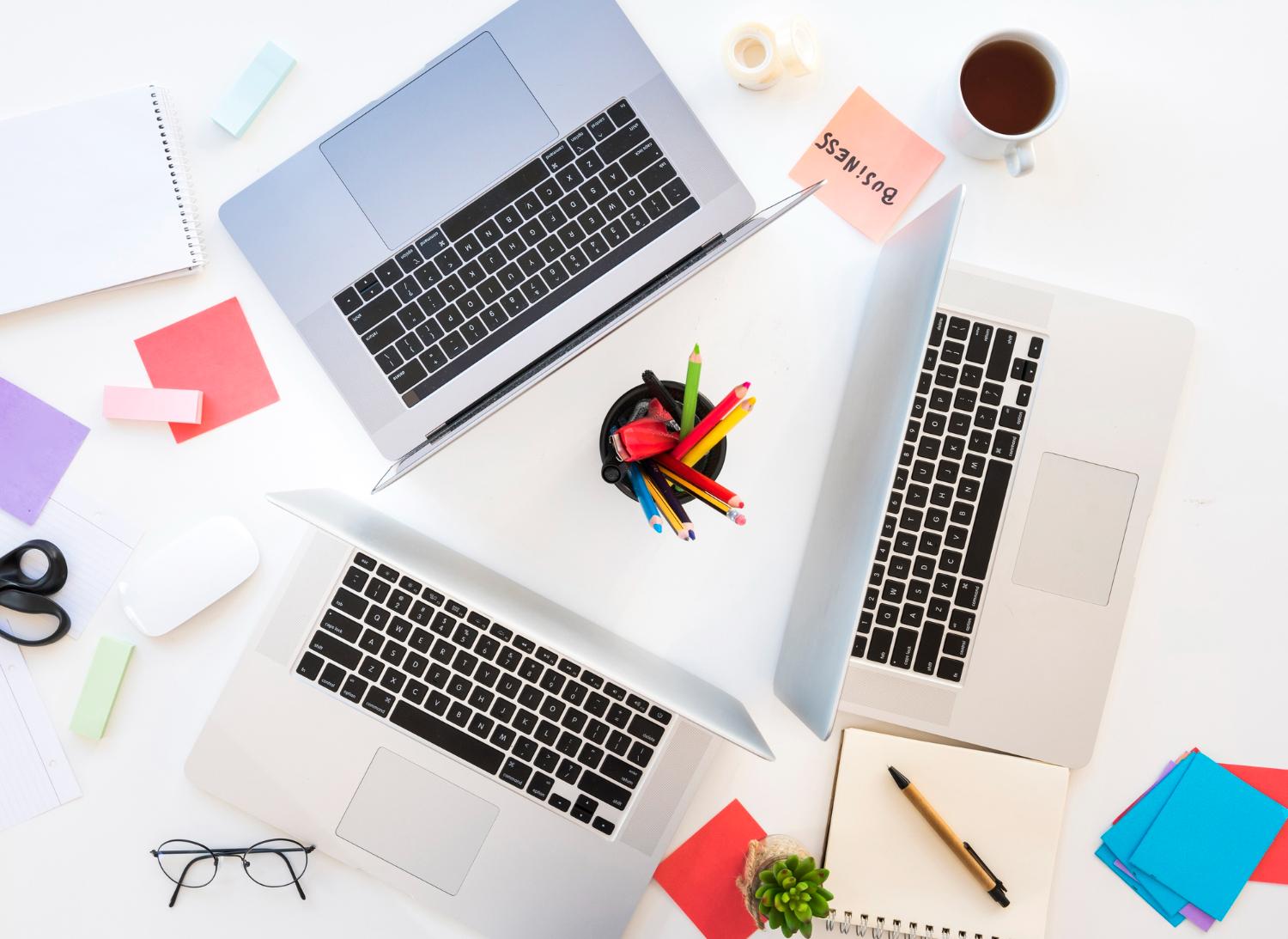 Several laptops arranged for comparison on a shared workspace