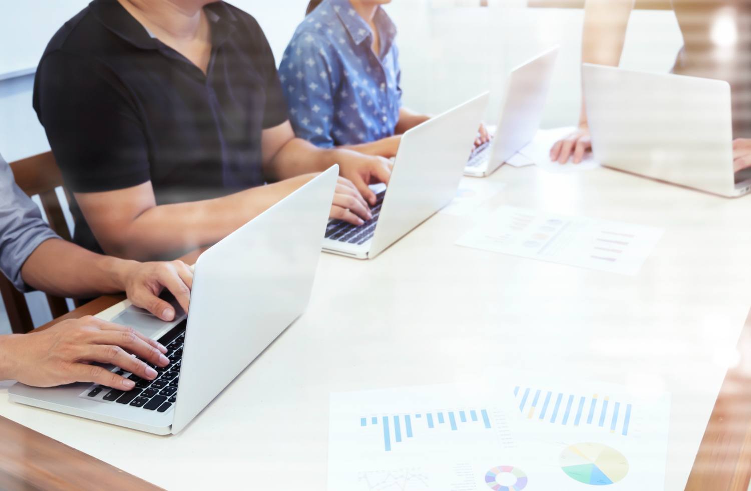 Business team working with laptops around a shared table