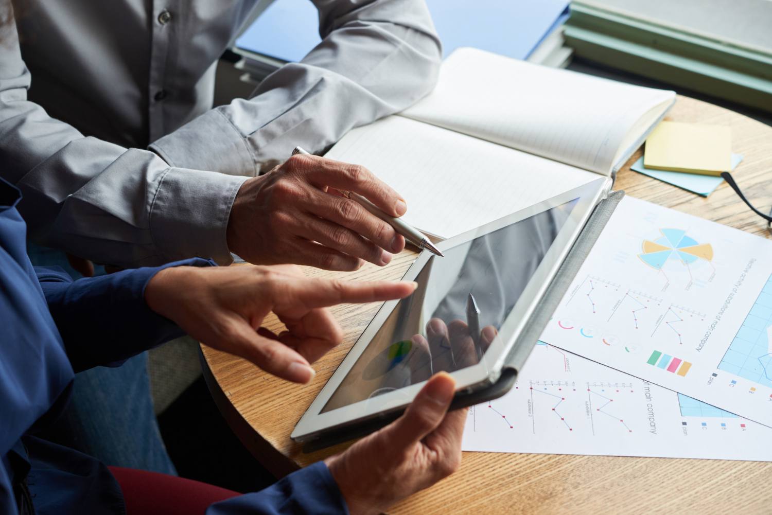Colleagues reviewing performance charts on a tablet