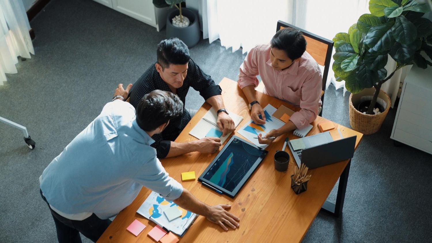 Business team reviewing service plans around a meeting table