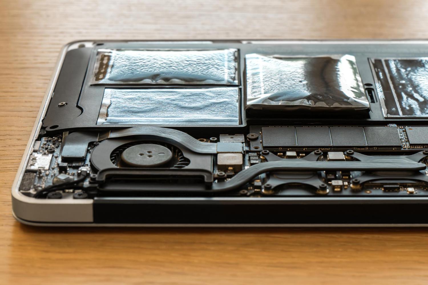 Swollen battery cells visible inside an opened laptop